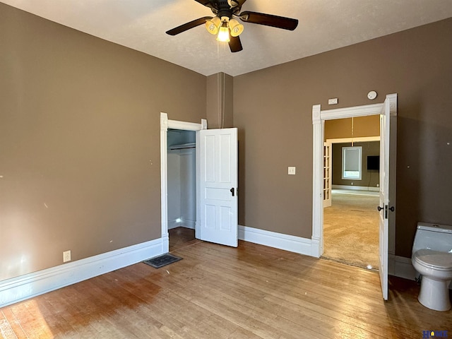 339 S Columbia Ave, Seward, NE 68434 - unfurnished bedroom featuring wood finished floors, baseboards, a ceiling fan, and a closet