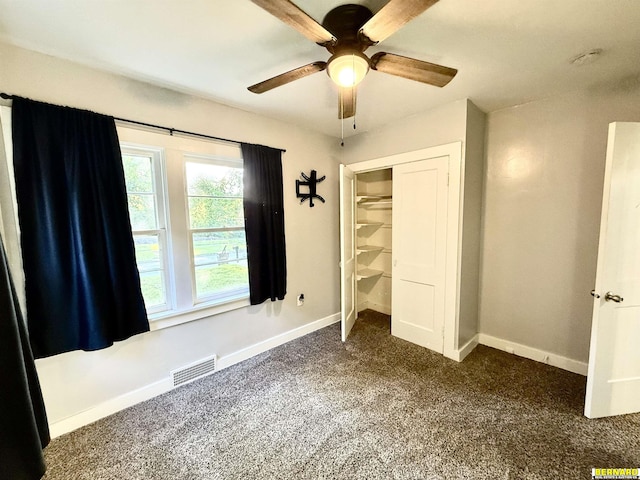 518 N 18th St, Nebraska City, NE 68410 - unfurnished bedroom with dark carpet, baseboards, a closet, and a ceiling fan