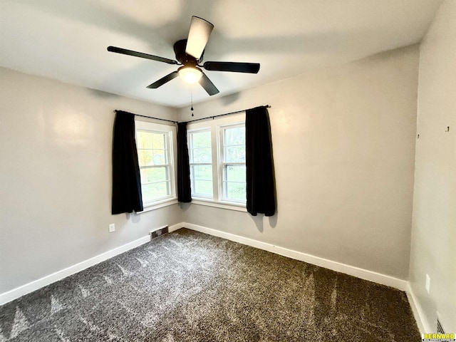 518 N 18th St, Nebraska City, NE 68410 - unfurnished room with baseboards, dark colored carpet, and a ceiling fan