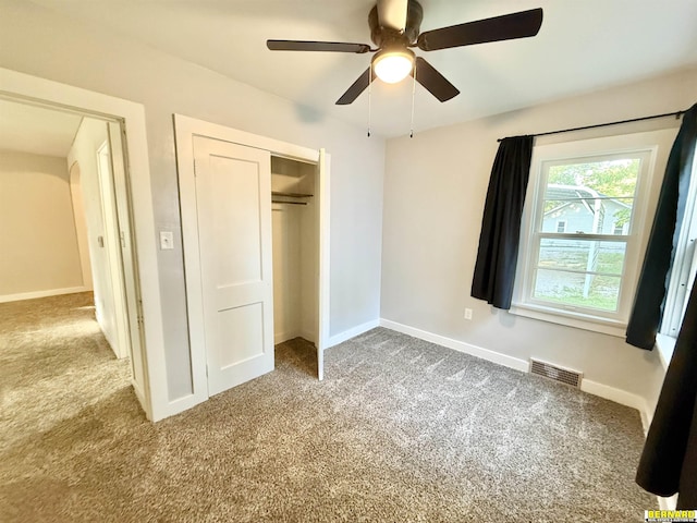 518 N 18th St, Nebraska City, NE 68410 - unfurnished bedroom featuring carpet floors, a closet, baseboards, and ceiling fan