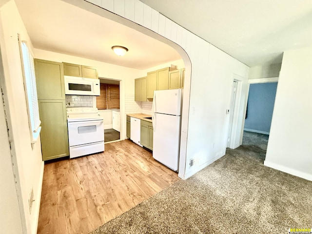 518 N 18th St, Nebraska City, NE 68410 - kitchen with white appliances, decorative backsplash, arched walkways, light wood-type flooring, and light countertops