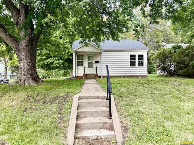 518 N 18th St, Nebraska City, NE 68410 - view of front of house with a front yard and a shingled roof
