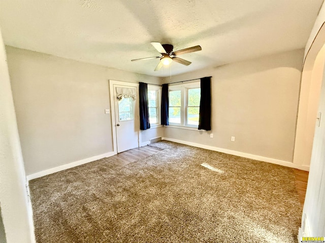 518 N 18th St, Nebraska City, NE 68410 - carpeted spare room with a ceiling fan, baseboards, and a textured ceiling
