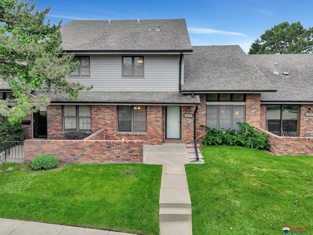 6609 Shenandoah Ct, Lincoln, NE 68510 - view of front of property with brick siding, a front lawn, and a shingled roof