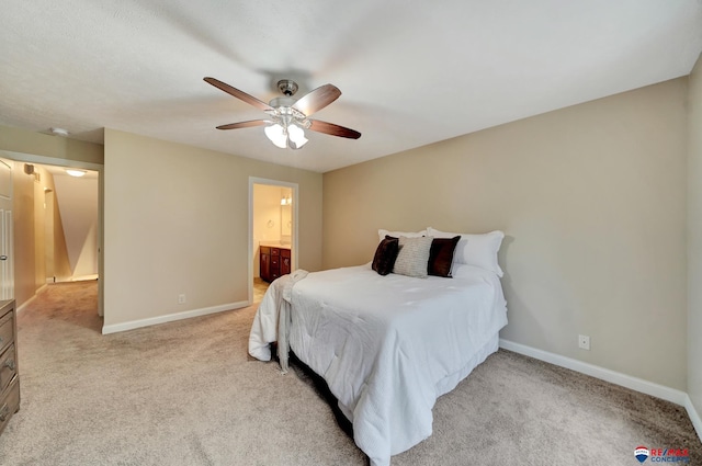 6609 Shenandoah Ct, Lincoln, NE 68510 - bedroom with light colored carpet, baseboards, ceiling fan, and connected bathroom