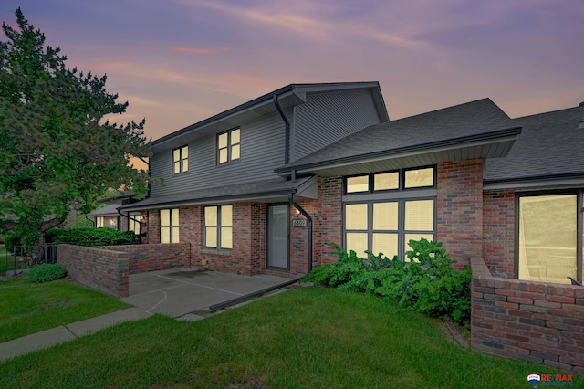 6609 Shenandoah Ct, Lincoln, NE 68510 - back of house featuring brick siding, roof with shingles, and a patio area