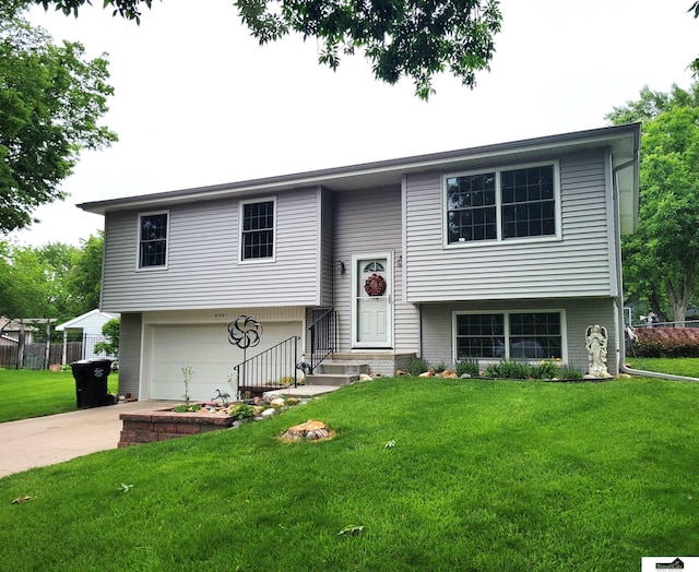 5201 Danbury Ct, Lincoln, NE 68512 - raised ranch featuring a front lawn, driveway, a garage, and brick siding
