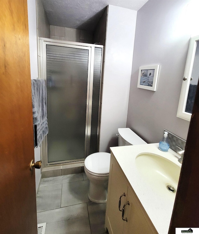 5201 Danbury Ct, Lincoln, NE 68512 - bathroom featuring vanity, toilet, a stall shower, and tile patterned floors