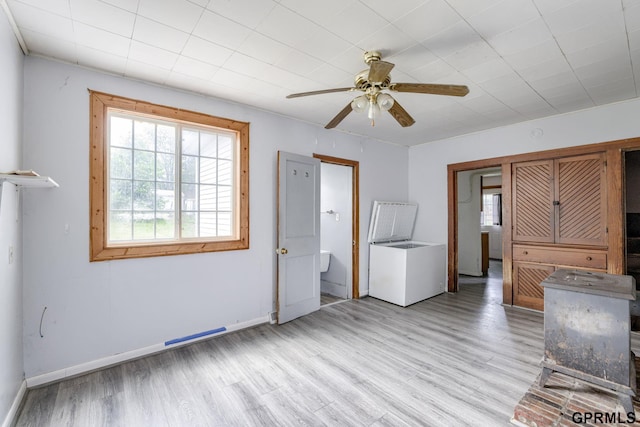 165 Monroe St, Bennet, NE 68317 - unfurnished living room featuring healthy amount of natural light, a ceiling fan, light wood-type flooring, and baseboards