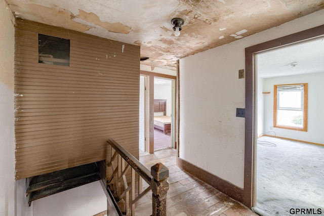 165 Monroe St, Bennet, NE 68317 - corridor featuring baseboards, an upstairs landing, and wood-type flooring