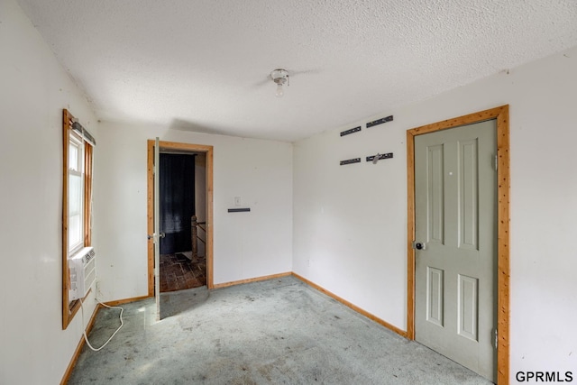 165 Monroe St, Bennet, NE 68317 - unfurnished room featuring baseboards, carpet floors, a textured ceiling, and cooling unit