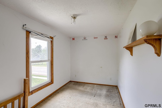 165 Monroe St, Bennet, NE 68317 - spare room with healthy amount of natural light, a textured ceiling, light carpet, and baseboards