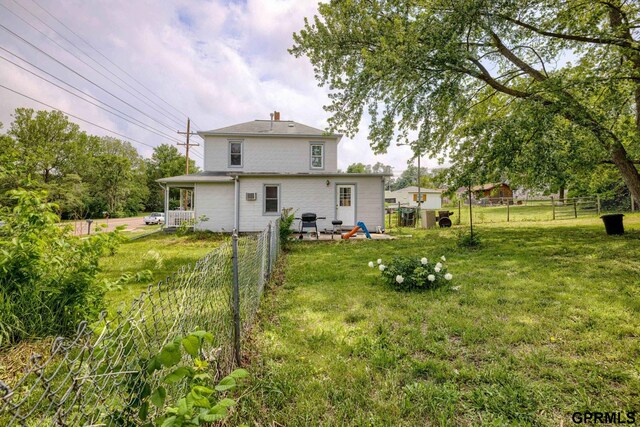 165 Monroe St, Bennet, NE 68317 - rear view of house featuring a chimney