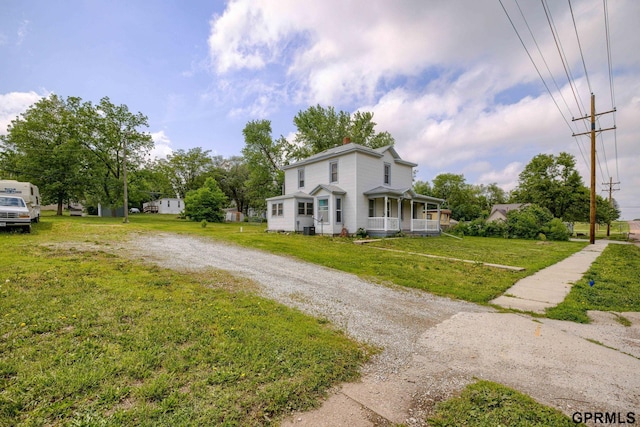 165 Monroe St, Bennet, NE 68317 - view of property exterior featuring a chimney, covered porch, and a lawn
