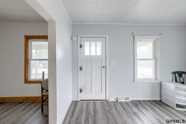 165 Monroe St, Bennet, NE 68317 - foyer entrance with wood finished floors, plenty of natural light, baseboards, and crown molding