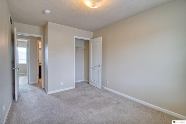 5306 S 195th St, Omaha, NE 68135 - unfurnished bedroom featuring light colored carpet, a textured ceiling, baseboards, and a closet