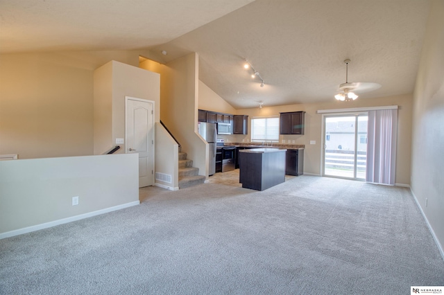 5306 S 195th St, Omaha, NE 68135 - kitchen with open floor plan, stainless steel appliances, vaulted ceiling, a kitchen island, and dark brown cabinets