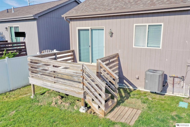 5306 S 195th St, Omaha, NE 68135 - doorway to property with central AC unit, a deck, a yard, and a shingled roof