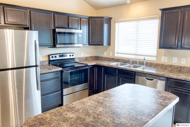 5306 S 195th St, Omaha, NE 68135 - kitchen with stainless steel appliances, a sink, dark countertops, dark brown cabinetry, and lofted ceiling