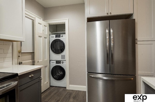 131 S 39th St Unit 6, Omaha, NE 68131 - washroom with stacked washer / drying machine, dark wood finished floors, and baseboards