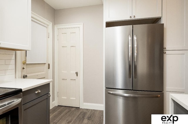 131 S 39th St Unit 6, Omaha, NE 68131 - kitchen with appliances with stainless steel finishes, wood finished floors, light countertops, baseboards, and white cabinetry