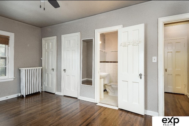 131 S 39th St Unit 6, Omaha, NE 68131 - unfurnished bedroom with radiator, wood finished floors, tile walls, ensuite bathroom, and baseboards