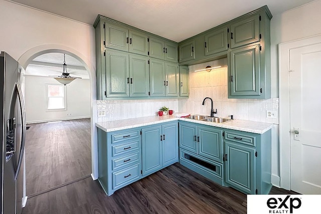 2626 N 67th St, Omaha, NE 68104 - kitchen with stainless steel refrigerator with ice dispenser, a sink, dark wood-style floors, and decorative backsplash