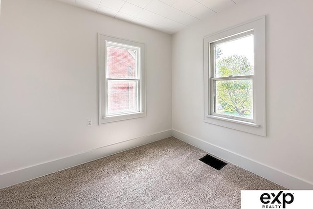 2626 N 67th St, Omaha, NE 68104 - carpeted empty room featuring plenty of natural light and baseboards
