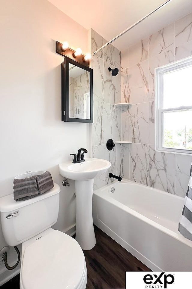 2626 N 67th St, Omaha, NE 68104 - bathroom with toilet, bathing tub / shower combination, and wood finished floors