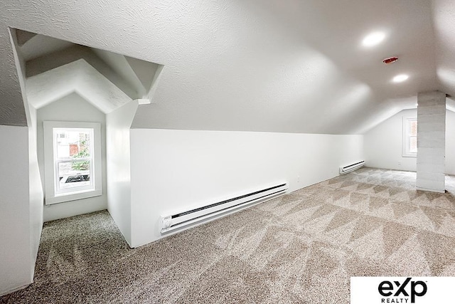 2626 N 67th St, Omaha, NE 68104 - additional living space featuring lofted ceiling, carpet floors, a baseboard radiator, a baseboard heating unit, and healthy amount of natural light