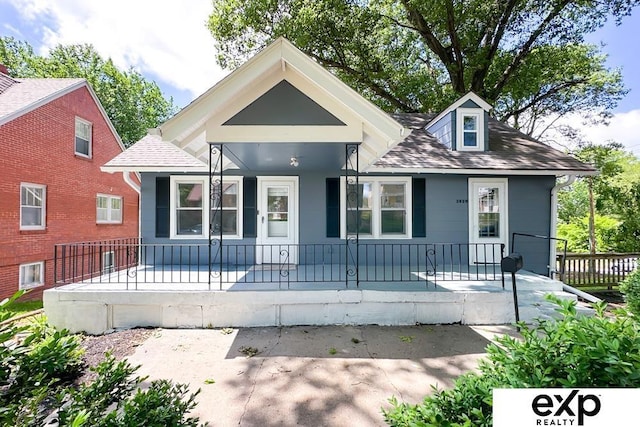 2626 N 67th St, Omaha, NE 68104 - bungalow-style home with a porch and roof with shingles