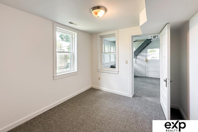 2626 N 67th St, Omaha, NE 68104 - spare room featuring dark carpet and baseboards