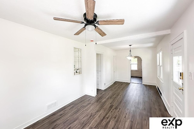 2626 N 67th St, Omaha, NE 68104 - empty room with baseboards, dark wood-style flooring, ceiling fan, arched walkways, and a baseboard heating unit