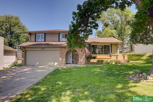 11680 Meredith Ave, Omaha, NE 68164 - tri-level home featuring brick siding, concrete driveway, a front yard, and a garage