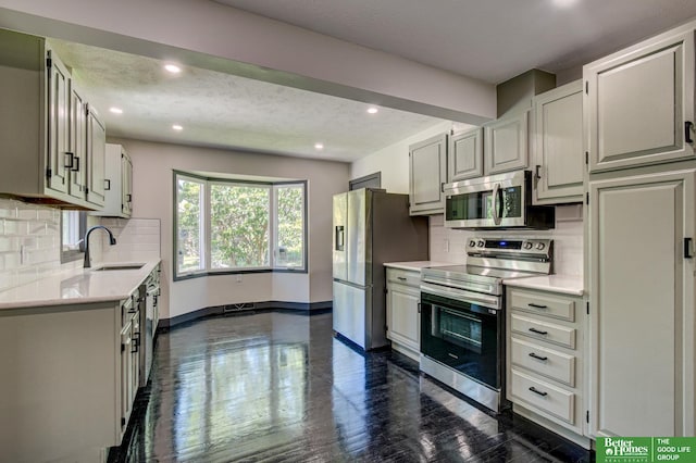 11680 Meredith Ave, Omaha, NE 68164 - kitchen featuring stainless steel appliances, a sink, backsplash, baseboards, and recessed lighting