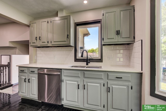 11680 Meredith Ave, Omaha, NE 68164 - kitchen with stainless steel dishwasher, a sink, light countertops, backsplash, and plenty of natural light