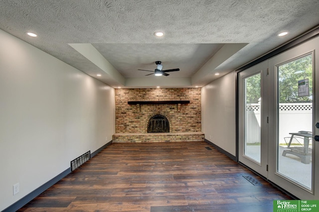 11680 Meredith Ave, Omaha, NE 68164 - unfurnished living room featuring wood finished floors, a brick fireplace, ceiling fan, a textured ceiling, and baseboards