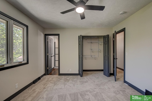 11680 Meredith Ave, Omaha, NE 68164 - unfurnished bedroom featuring a textured ceiling, light carpet, baseboards, a closet, and a ceiling fan