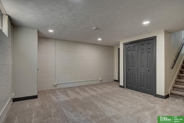 11680 Meredith Ave, Omaha, NE 68164 - finished below grade area featuring stairway, carpet, concrete block wall, a textured ceiling, and baseboards