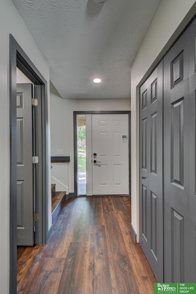 11680 Meredith Ave, Omaha, NE 68164 - foyer entrance with dark wood finished floors, stairs, baseboards, a textured ceiling, and recessed lighting