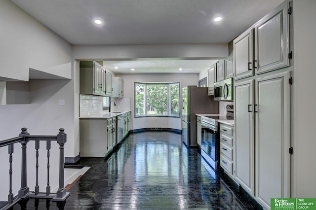 11680 Meredith Ave, Omaha, NE 68164 - kitchen featuring stainless steel appliances, light countertops, baseboards, tasteful backsplash, and a sink