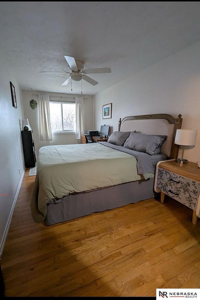 2515 3rd Street Plz, Omaha, NE 68108 - bedroom with wood-type flooring, baseboards, and ceiling fan