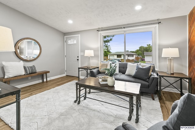4656 Redick Ave, Omaha, NE 68152 - living area with wood finished floors, recessed lighting, vaulted ceiling, and baseboards