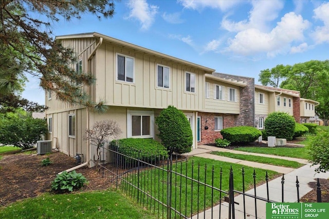 5143 S 126th Plz Unit 22, Omaha, NE 68137 - view of front of home featuring central AC unit and board and batten siding