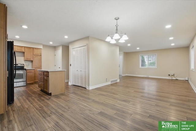 5143 S 126th Plz Unit 22, Omaha, NE 68137 - kitchen featuring a chandelier, light countertops, dark wood finished floors, recessed lighting, and a center island