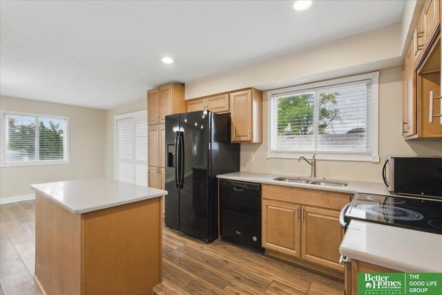 5143 S 126th Plz Unit 22, Omaha, NE 68137 - kitchen featuring black appliances, a sink, healthy amount of natural light, a center island, and recessed lighting
