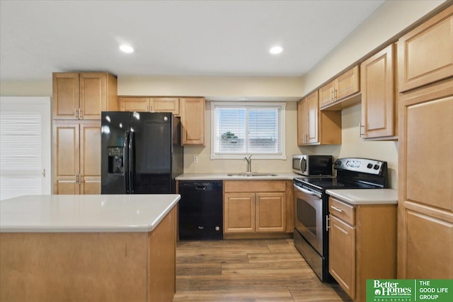5143 S 126th Plz Unit 22, Omaha, NE 68137 - kitchen featuring black appliances, a sink, wood finished floors, light countertops, and recessed lighting