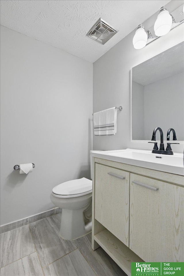 5143 S 126th Plz Unit 22, Omaha, NE 68137 - bathroom with vanity, toilet, wood finished floors, and baseboards