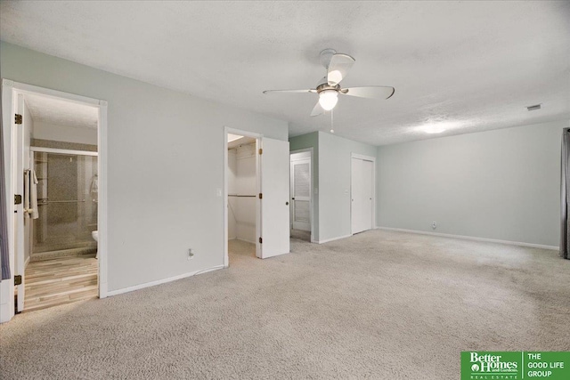 5143 S 126th Plz Unit 22, Omaha, NE 68137 - unfurnished bedroom featuring carpet floors, baseboards, ensuite bathroom, and a ceiling fan