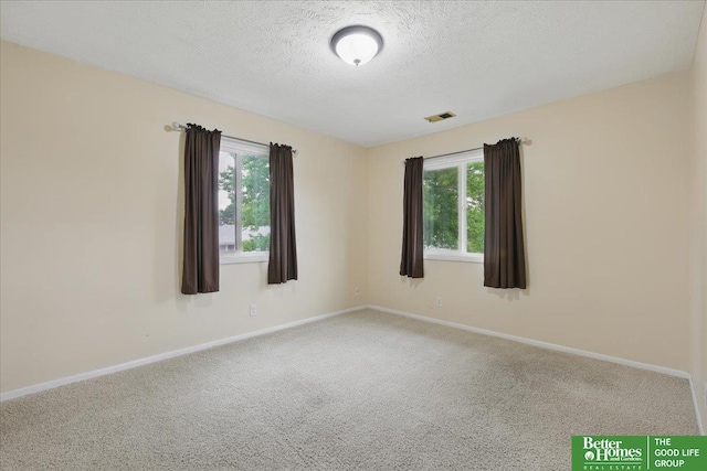 5143 S 126th Plz Unit 22, Omaha, NE 68137 - unfurnished room featuring carpet flooring, a textured ceiling, and baseboards